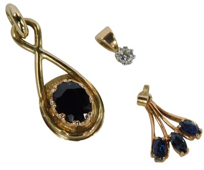 Lot 210 - Two 9ct gold stone set pendants, one of figure...