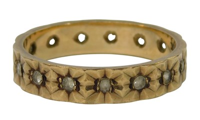 Lot 252 - A white stone set eternity band, yellow metal,...