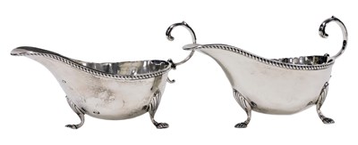 Lot 122 - A pair of George V silver sauce boats, raised...