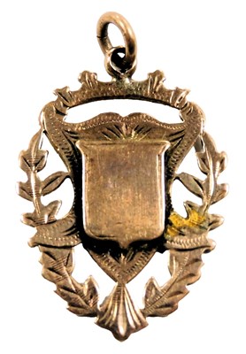 Lot 211 - A 9ct gold shield medallion, reserve engraved...