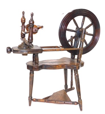 Lot 161 - An early 20thC oak spinning wheel, 55cm wide.