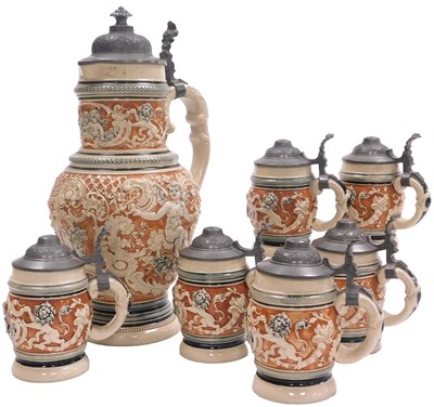 Lot 450 - Six German stoneware steins, relief decorated...
