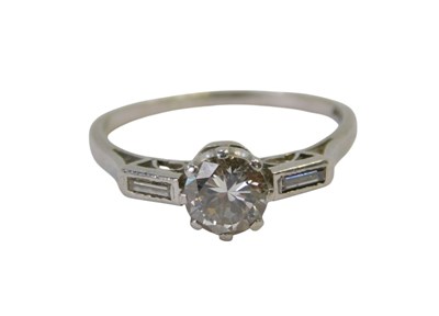 Lot 53 - A diamond ring, the central diamond claw set...