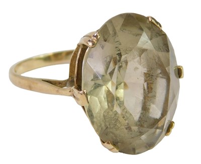 Lot 418 - A 9ct gold and smokey quartz ring, the oval...