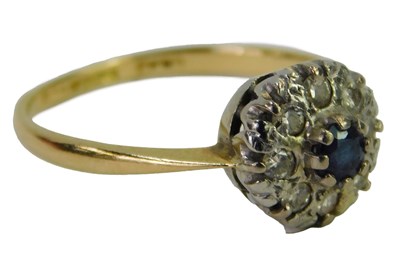 Lot 440 - A sapphire and diamond cluster ring, the...