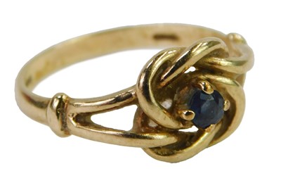 Lot 445 - A 9ct gold and sapphire knot ring, the central...