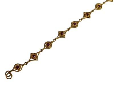 Lot 454 - A 9ct gold and ruby set floral link bracelet,...