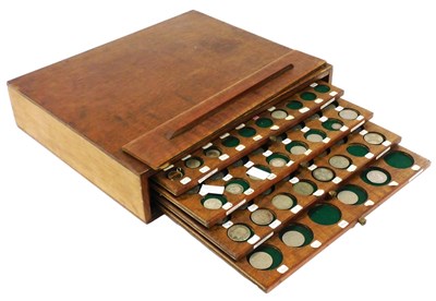 Lot 519 - A four drawer coin cabinet, containing Edward...