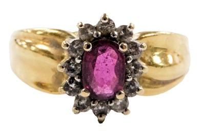 Lot 219 - An 18ct gold ruby and diamond ring, the oval...