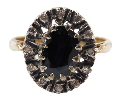 Lot 562 - A 9ct gold sapphire and diamond ring, the oval...