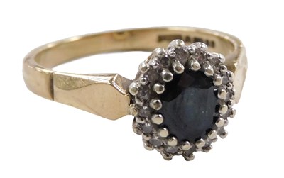 Lot 564 - A 9ct gold sapphire and diamond ring, the oval...