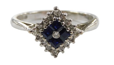Lot 556 - An 18ct white gold sapphire and diamond ring,...