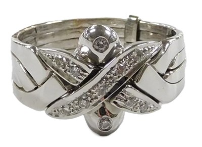 Lot 561 - An 18ct gold and diamond set four band ring,...