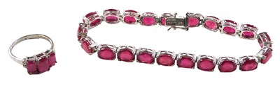 Lot 566 - A ruby tennis bracelet, set with twenty one...