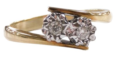 Lot 567 - A 9ct gold and diamond two stone ring, in an...