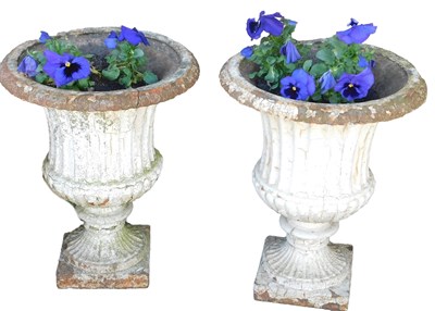 Lot 664 - A pair of white painted cast iron garden urns,...