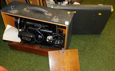 Lot 2170 - A cased Singer sewing machine. Buyer Note:...