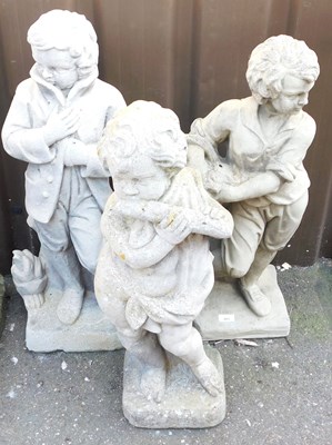 Lot 669 - Three concrete garden figures, comprising a...