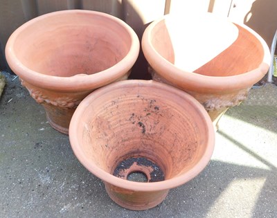 Lot 673 - Three graduated terracotta garden plant pots,...