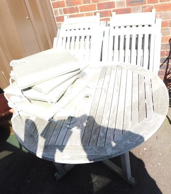 Lot 674 - A circular garden table, with a parasole...