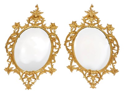 Lot 679 - A pair of rococo style oval gilt wall mirrors,...