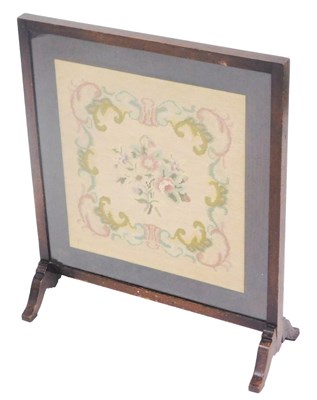 Lot 740 - An early 20thC oak fire screen, with a floral...