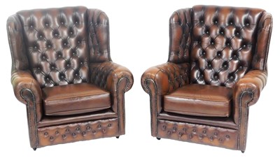Lot 689 - A pair of brown leather wing back armchairs,...
