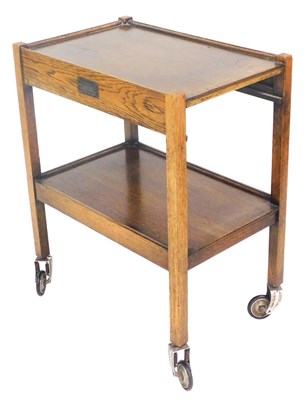 Lot 722 - A mid century oak trolley, raised on metal...