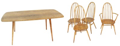 Lot 724 - An Ercol light elm and beech dining table,...