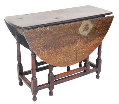 Lot 753 - A Georgian oak gate leg dining table, raised...