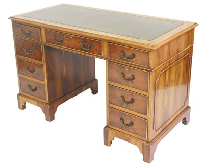 Lot 771 - A yew wood twin pedestal desk, with a gilt...