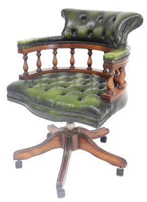 Lot 812 - A mahogany and green leather captain's chair,...