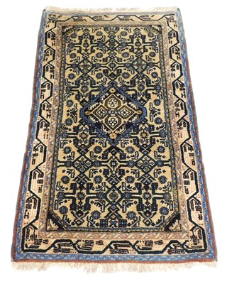 Lot 820 - An Iranian cream ground rug, with a central...