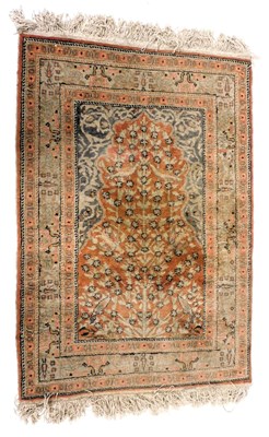 Lot 823 - A Turkish red ground prayer rug, the mihrab...
