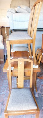 Lot 1001 - An early 20thC oak dining table, the fold over...