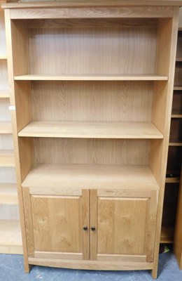Lot 1002 - A contemporary oak veneer open bookcase, with...