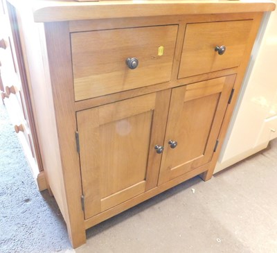 Lot 1010 - A contemporary oak side cabinet, the...