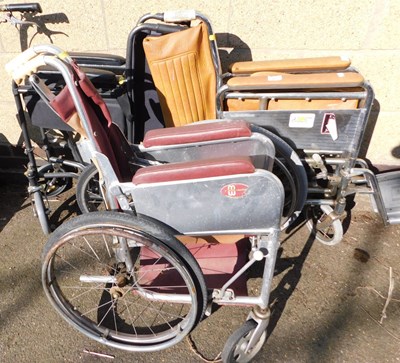 Lot 1021 - A set of three folding wheelchairs, in varying...