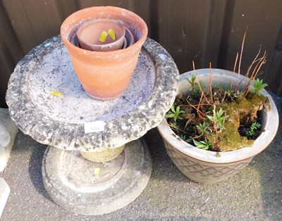 Lot 1034 - A composition stone birdbath, on a circular...