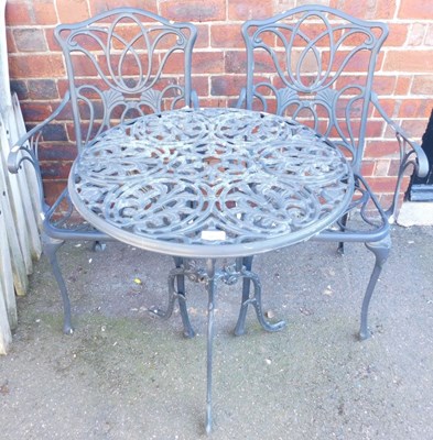 Lot 1035 - A black painted aluminium garden set,...