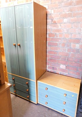 Lot 1141 - A faux stained pine double wardrobe, with...