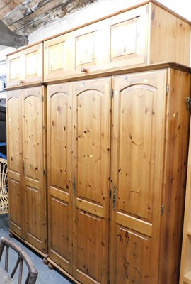 Lot 1030 - A pine bedroom suite, comprising triple...
