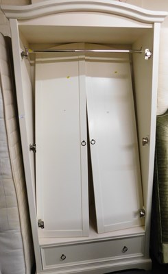 Lot 1145 - A double wardrobe, with a frieze drawer to the...