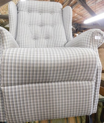 Lot 1155 - A manual reclining armchair, upholstered in...
