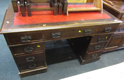 Lot 1057 - A mahogany twin pedestal desk with a tooled...