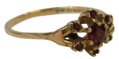 Lot 618 - A 9ct gold and garnet flower head ring, the...