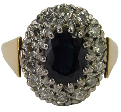 Lot 629 - An 18ct gold sapphire and diamond cluster ring,...