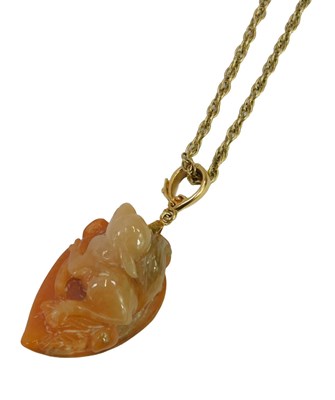 Lot 631 - A Chinese carved hardstone pendant, depicting...