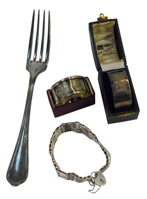 Lot 639 - A silver gate bracelet, with a heart-shaped...