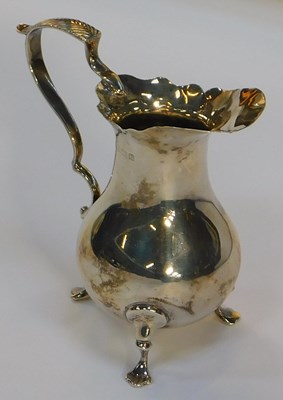Lot 641 - A George V silver milk jug, with an engraved...